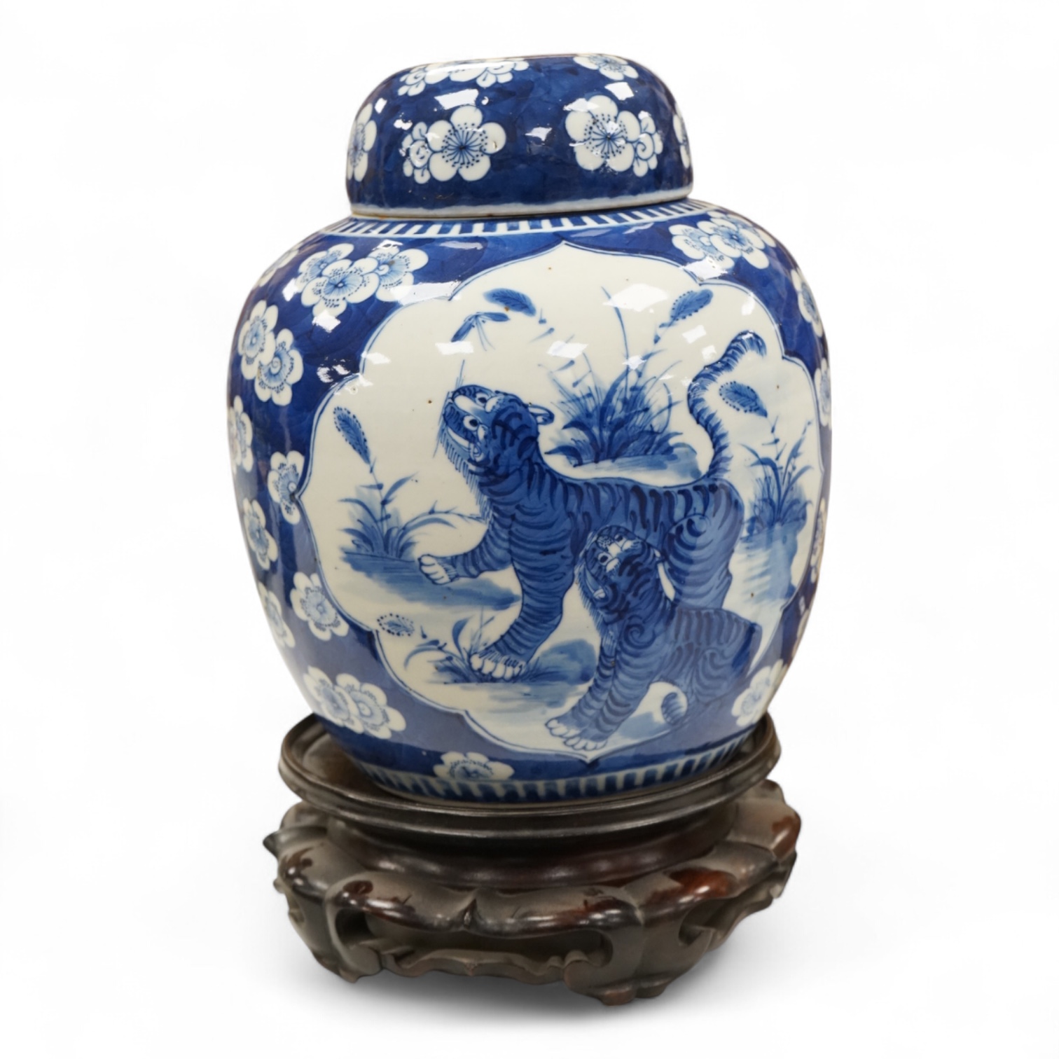 A 19th century Chinese blue and white jar and cover, on hardwood stand, 34cm high